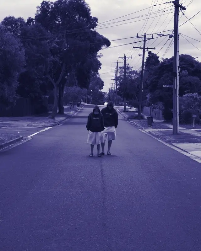 Two people wearing Woven hoodies on the street