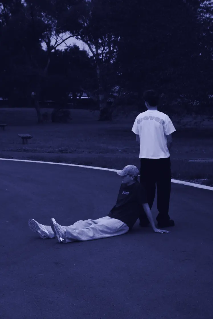 Woven tee mid-backflip on the park path
